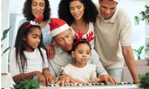 family gathered around piano playing christmas music and wanting to buy a new piano